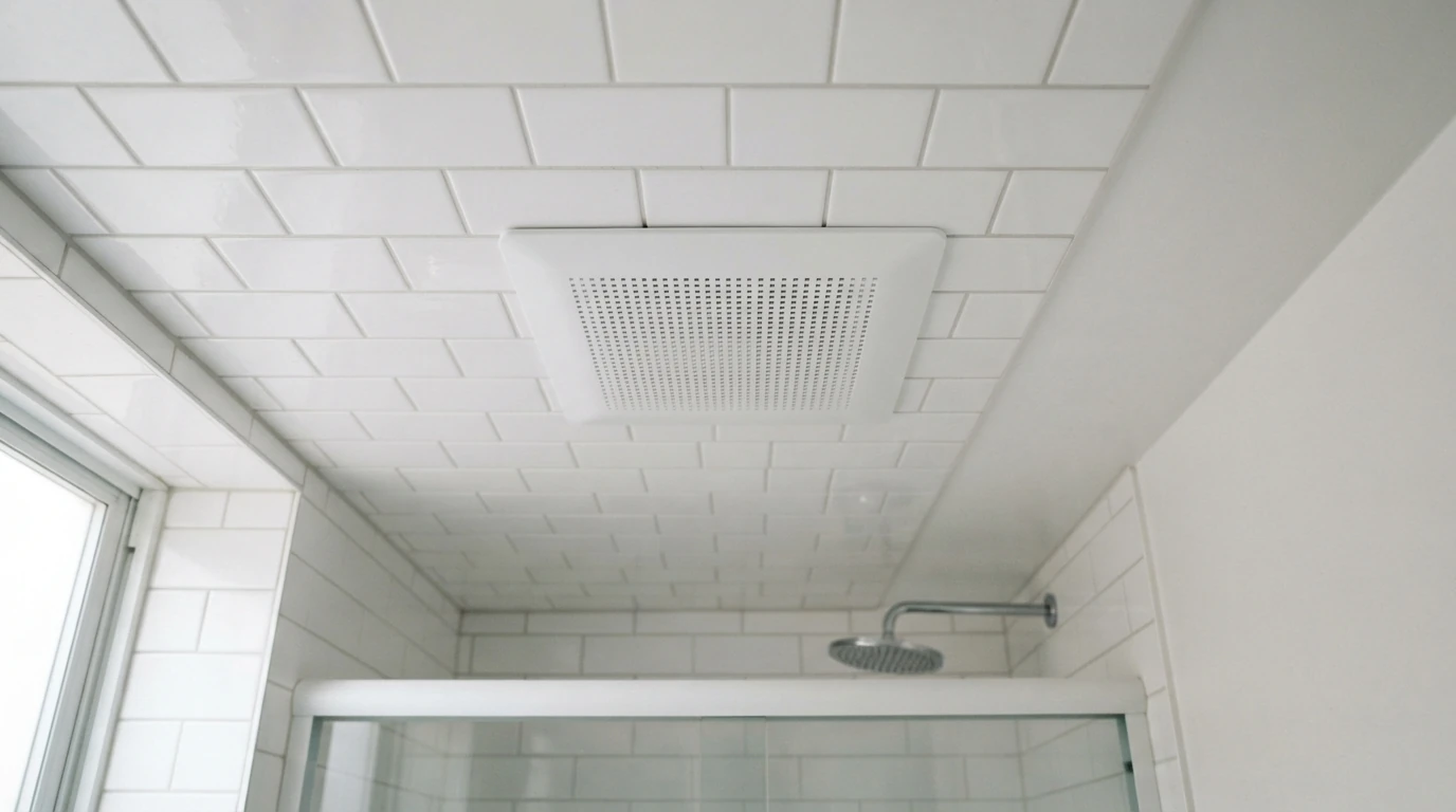 New low-profile exhaust fan grille in a tiled New York bathroom ceiling